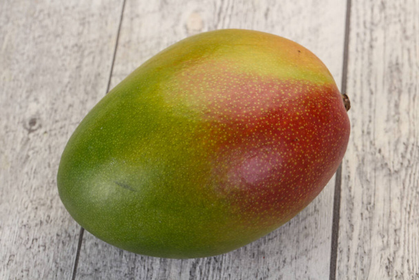 Sweet tasty mango over wooden background - Photo, Image