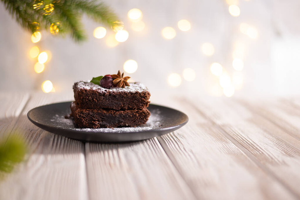 Chocolate cake on the festive celebration table with christmas decorations and copy space - Valokuva, kuva
