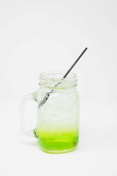 A closeup of green paint mixture in a mason jar isolated on a white background - Valokuva, kuva