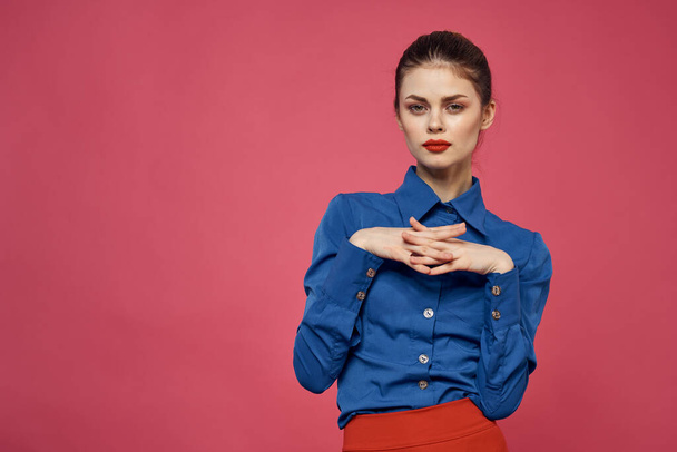fashionable woman in blue shirt on pink background Red skirt emotions model gesturing with hands cropped view Copy Space - Фото, изображение