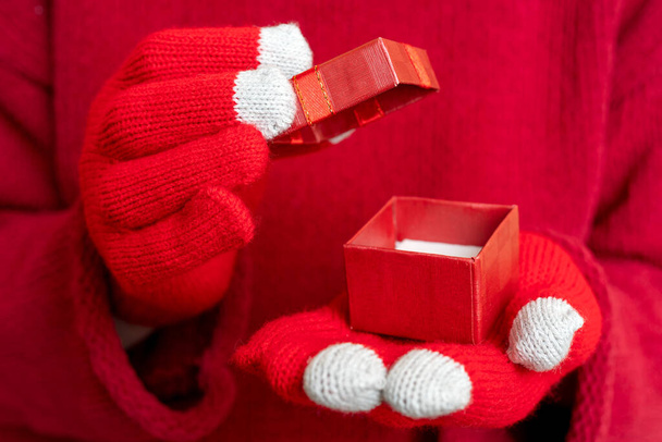 A closeup shot of a Christmas gift box. Festive composition. Red background. - Zdjęcie, obraz