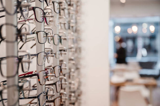 A selective focus shot of a row of glasses on display at an optics store - Valokuva, kuva