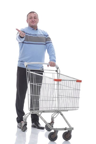 in full growth. confident casual man with shopping cart - Foto, Imagem