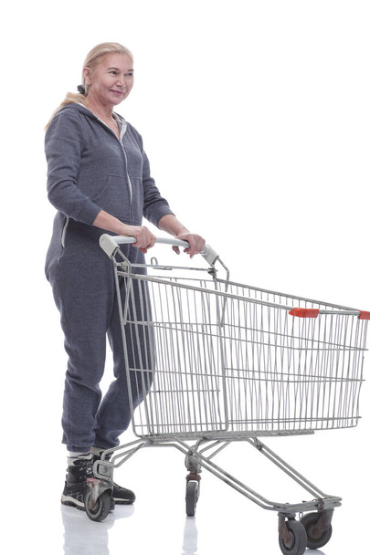in full growth. smiling woman with shopping cart pointing at you - Fotó, kép