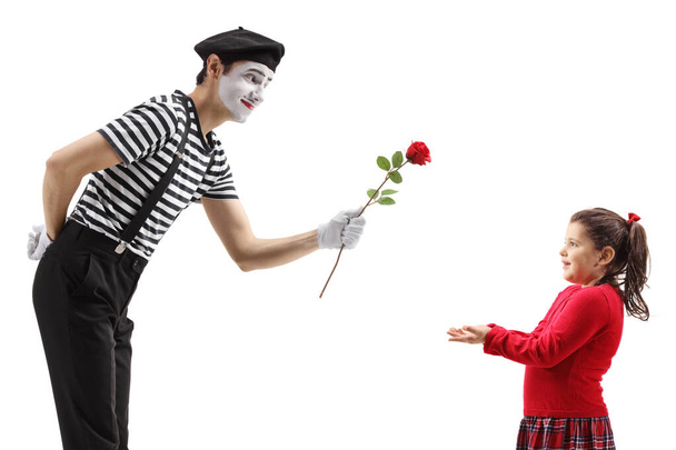 Mime giving a red rose to a little girl isolated on white background - Foto, Bild