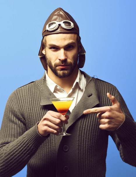 bearded pilot with cocktail in glass - Fotó, kép