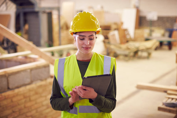 Female Safety Inspector With Digital Tablet At Construction Site - Фото, изображение