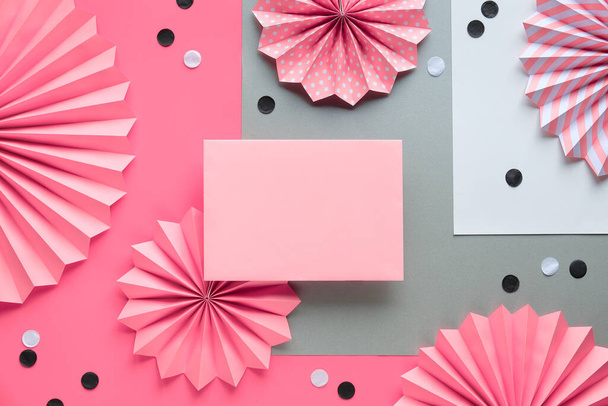 Circle fans and confetti on pink background. Creative frame for greeting text on blank card, flat lay. Modern vibrant decorations for party, celebration in pink, black and white - 写真・画像
