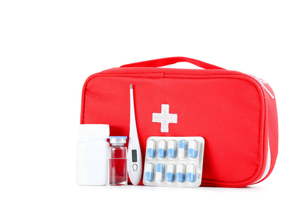 First aid kit with medical supplies isolated on white background - Fotó, kép