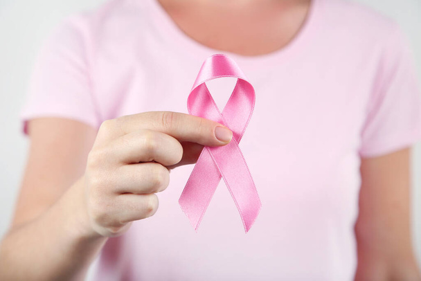 Breast cancer concept. Female hand with pink ribbon - Fotografie, Obrázek