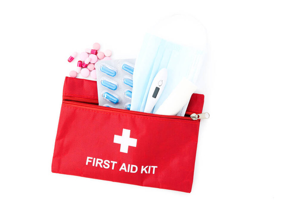 First aid kit with medical supplies isolated on white background - Foto, Bild