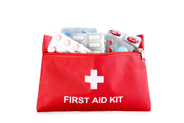 First aid kit with medical supplies isolated on white background - Foto, afbeelding