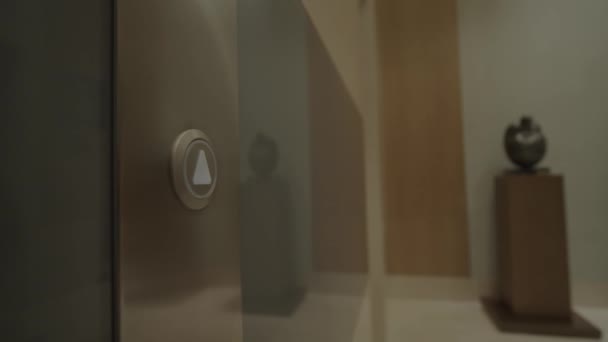 オフィスセンターまたはホテルの女性ハンドプッシュエレベーターボタン。リフトボタンを押す若い女性。指が上に向けて矢印でボタンを押します。閉鎖だ。4K - 映像、動画
