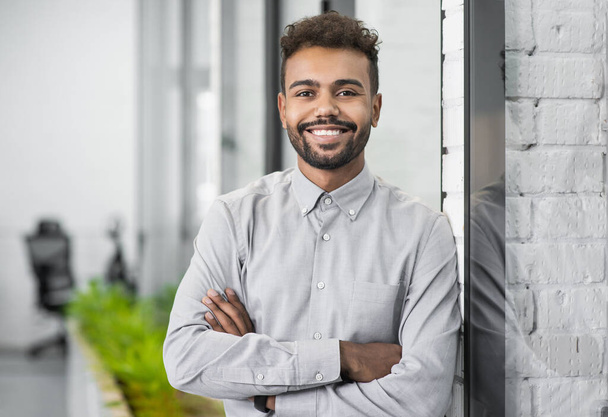 portrait of smiling young man standing in office - Fotografie, Obrázek