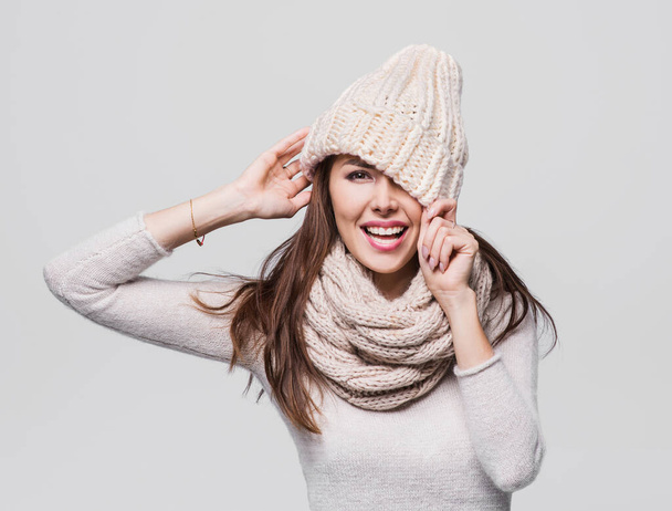 Beautiful woman isolated winter portrait. Smiling girl wearing warm clothes having fun - 写真・画像
