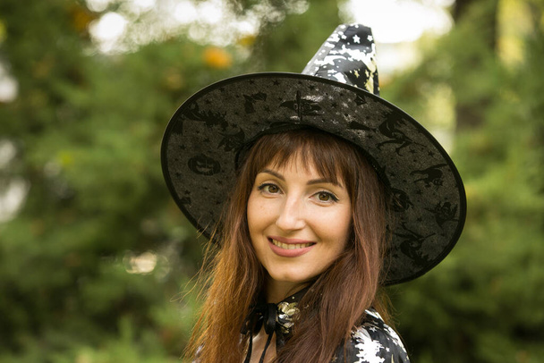 Halloween. Beautiful young woman in a festive mood at a Halloween picnic. Warm autumn October day. Emotion concept. - Photo, Image