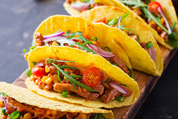 Een taco. Mexicaanse taco 's met rundvlees, maïs en salsa. Mexicaanse keuken. kopieerruimte. - Foto, afbeelding