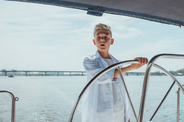 handsome Caucasian boy on the yacht - Zdjęcie, obraz
