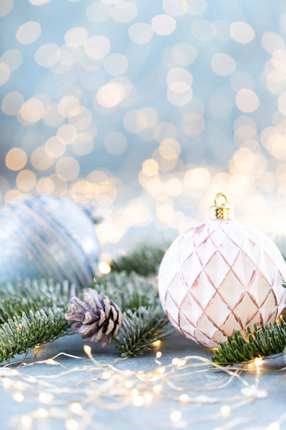Christmas spruce with ball and blurred shiny lights. - Valokuva, kuva