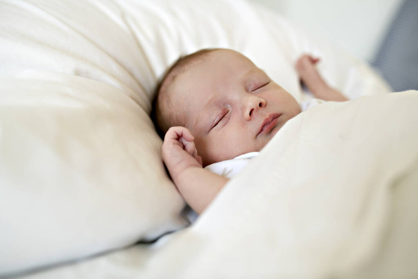 A Sweet newborn baby girl sleeping in white bed - Fotoğraf, Görsel