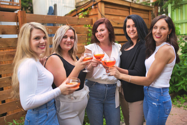 Group of girls friends who drink together in the backyard - Foto, afbeelding