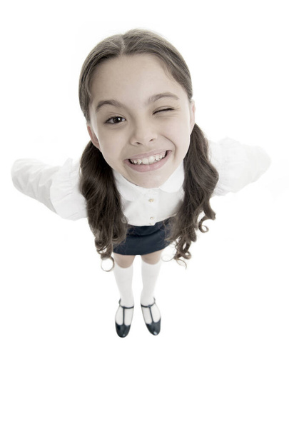 Cheerful smile. Student little kid adores school. Pupil of first grade. Celebrate knowledge day. September time to study. Girl cute pupil on white background. School uniform. Back to school - Valokuva, kuva