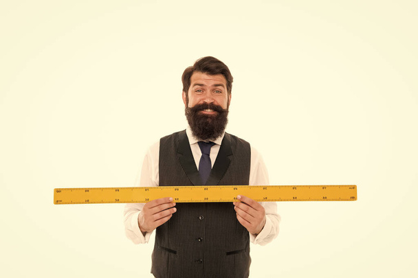 Learning metric system. School teacher. Size really matters. Man bearded hipster holding ruler. Measure length. Measure and control. Geometry theorem. Measure with centimeters. Size table concept - Φωτογραφία, εικόνα