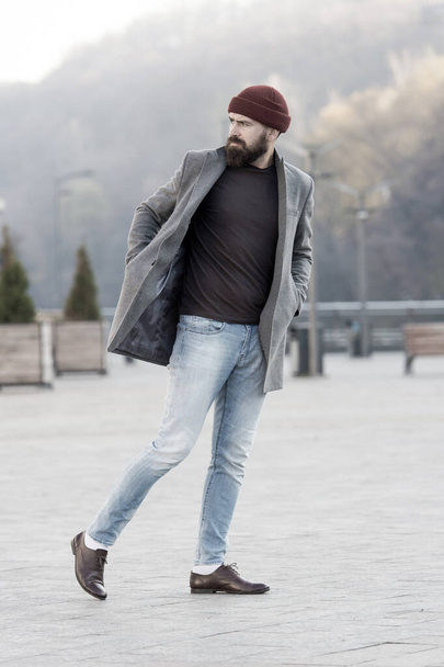 Hipster outfit and hat accessory. Stylish casual outfit spring season. Menswear and male fashion concept. Man bearded hipster stylish fashionable coat and hat. Comfortable outfit. Lumbersexual style - Zdjęcie, obraz