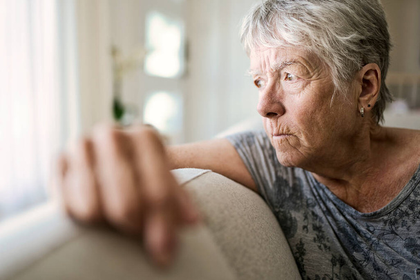 Portrait Of Senior Woman On Sofa Suffering From Depression - Fotografie, Obrázek