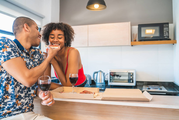 Portrait of happy young latin couple enjoying and having dinner at new home. Lifestyle and relationship concept. - Foto, imagen