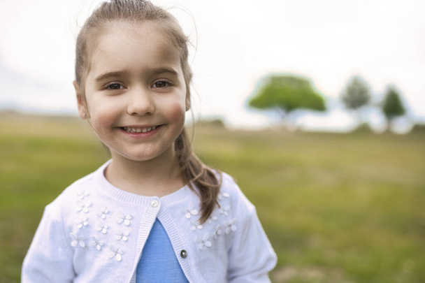 cute Portrait of a nice little girl outside - Фото, изображение