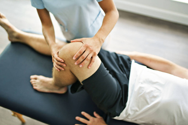 physiotherapist doing treatment with patient in bright office - Foto, imagen