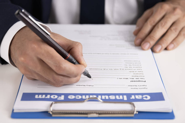 Страховой агент зум ручной записи автомобиля страховой заявление или страховой документ на рабочем столе - Фото, изображение