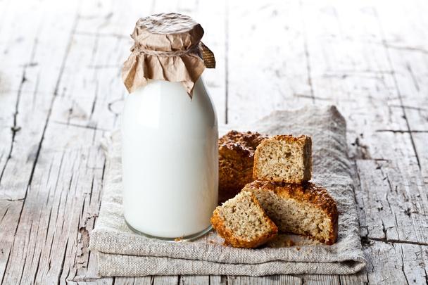 bottle of milk and fresh baked bread  - Photo, Image