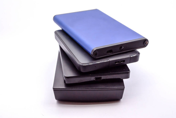 HDD - Stack of Portable Hard Disk Drives isolated on white background. Pile of External hard disk drives. - Photo, Image
