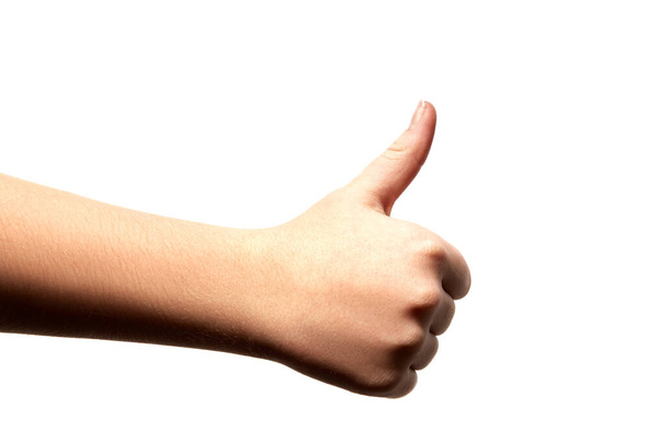 Kobieta nastoletnia ręka pokazuje kciuki w górę odizolowane na białym tle. Kciuk w górę. Jak gest do góry palcem.. - Zdjęcie, obraz