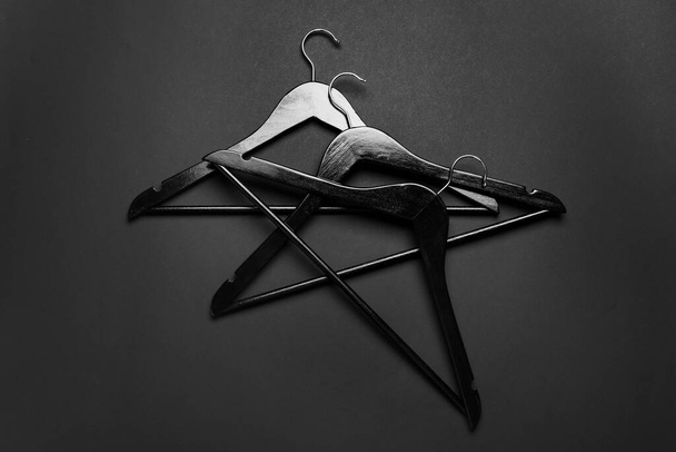 Clothes hangers on dark background - Photo, Image