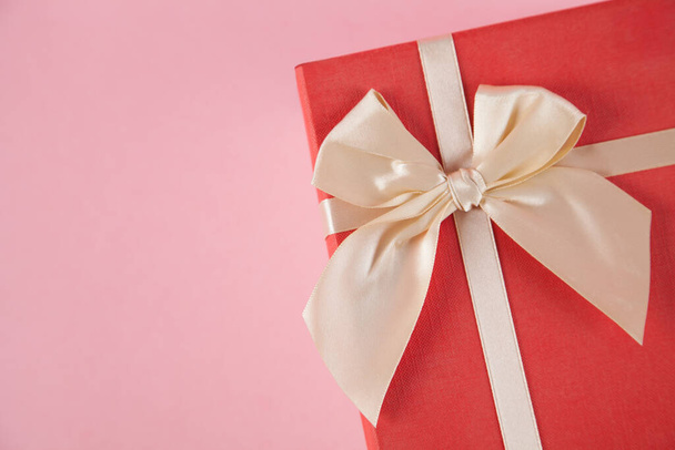 Gift box on an isolated pink background. Rectangular gift box. - Фото, изображение
