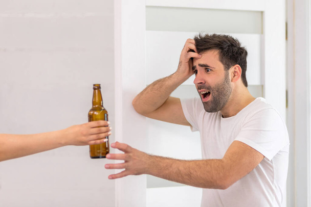 Photo of man being excited about bottle of beer in the morning. - Photo, Image