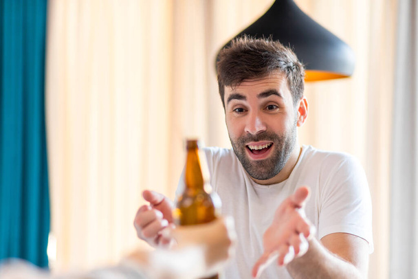 Photo of bearded man happy to get a bottle of bear. - Photo, Image