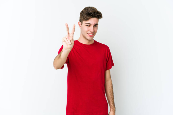 Young caucasian man isolated on white background showing number two with fingers. - Photo, Image