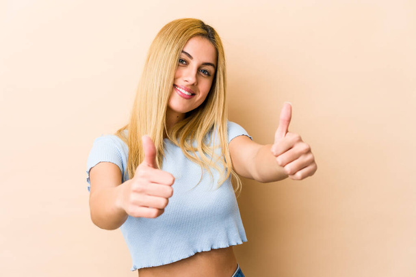 Young blonde caucasian woman with thumbs ups, cheers about something, support and respect concept. - Photo, Image