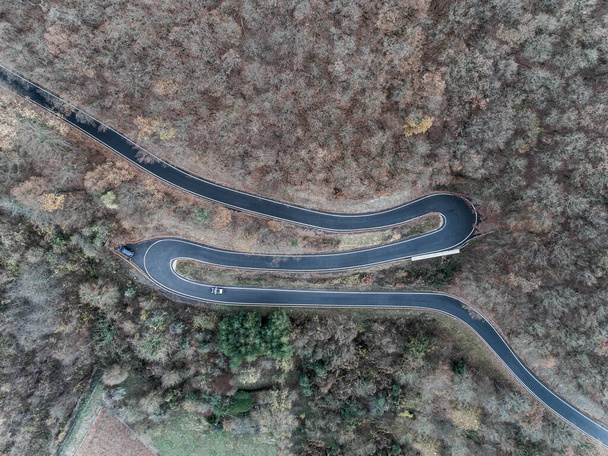 Seasons Concept winter or fall Aerial view Winding road serpentine mountain pass village Brodenbach Germany - Photo, Image