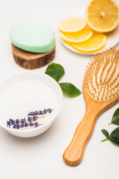 bowl with lavender, sliced lemon, brush, and soap on blurred white background - 写真・画像