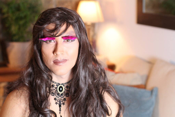 portrait of transgender woman in wig at home - Photo, Image