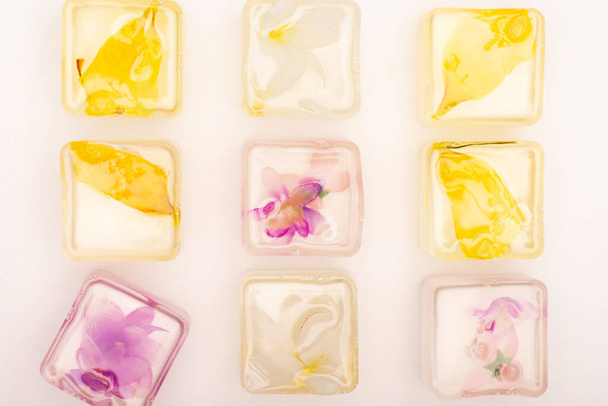 top view of frozen fruit and floral ice cubes on white background - Zdjęcie, obraz