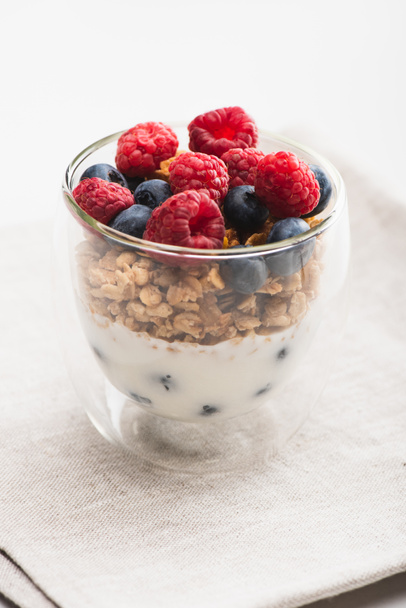delicious granola with berries and yogurt in glass cup - Foto, Bild