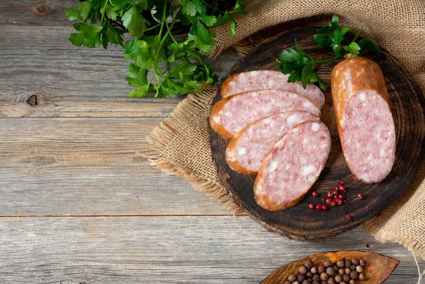 Sausage. Smoked sausage with spices on a wooden serving Board. Tasty meat sausages made from turkey meat. Copyspace - 写真・画像