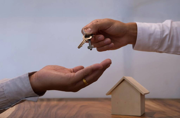 Real estate agent giving keys to customer after contract signature - Photo, Image