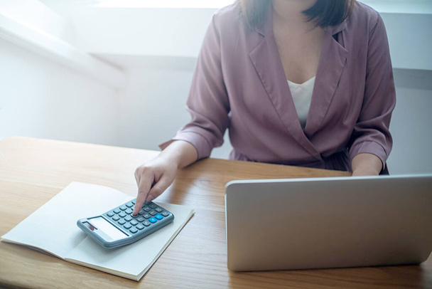 Business women checking  bills. taxes bank account balance and calculating  annual financial statements of company. Accounting  Audit Concept. - Photo, Image